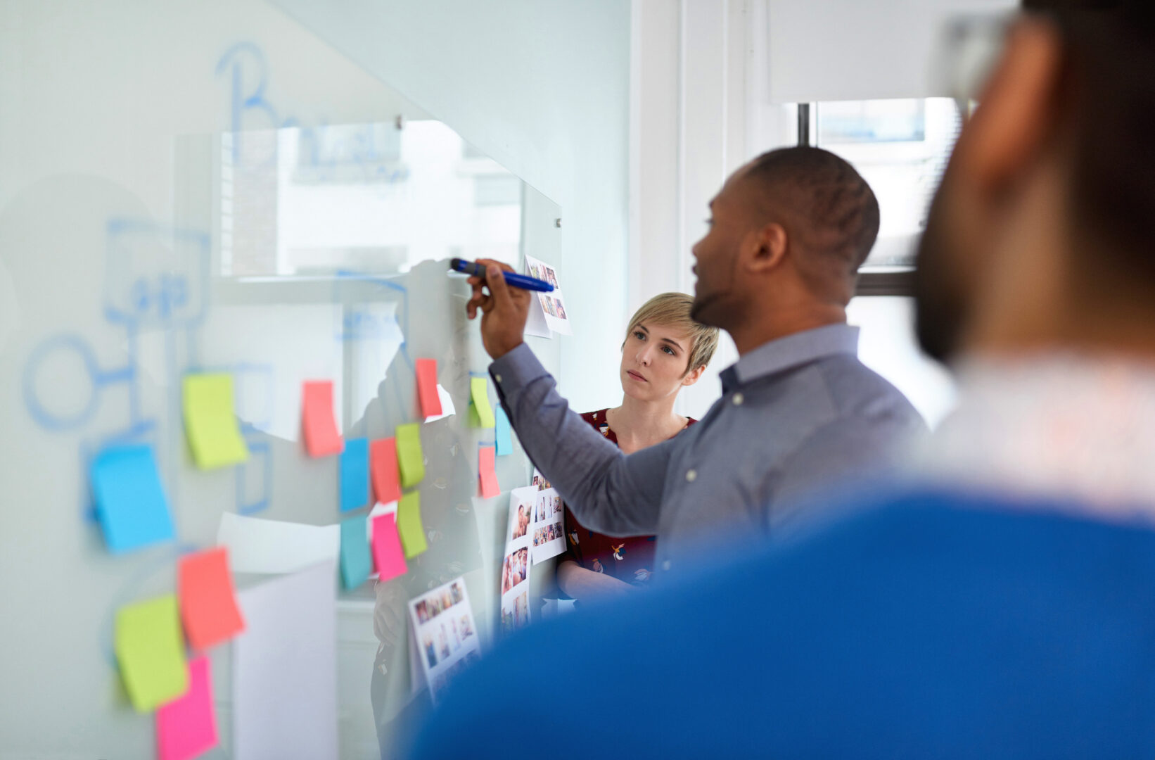 diverse-team-of-creative-millennial-coworkers-in-a-startup-brainstorming-strategies